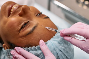 Professional cosmetic practitioner performing dermal filler injections for subtle facial rejuvenation